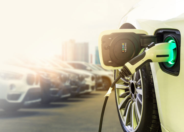 A photo of an EV connected to a home wall charging unit